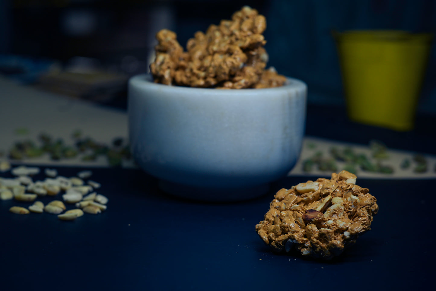 Chocolate peanut chikki 500g box with chikki pieces on wooden table