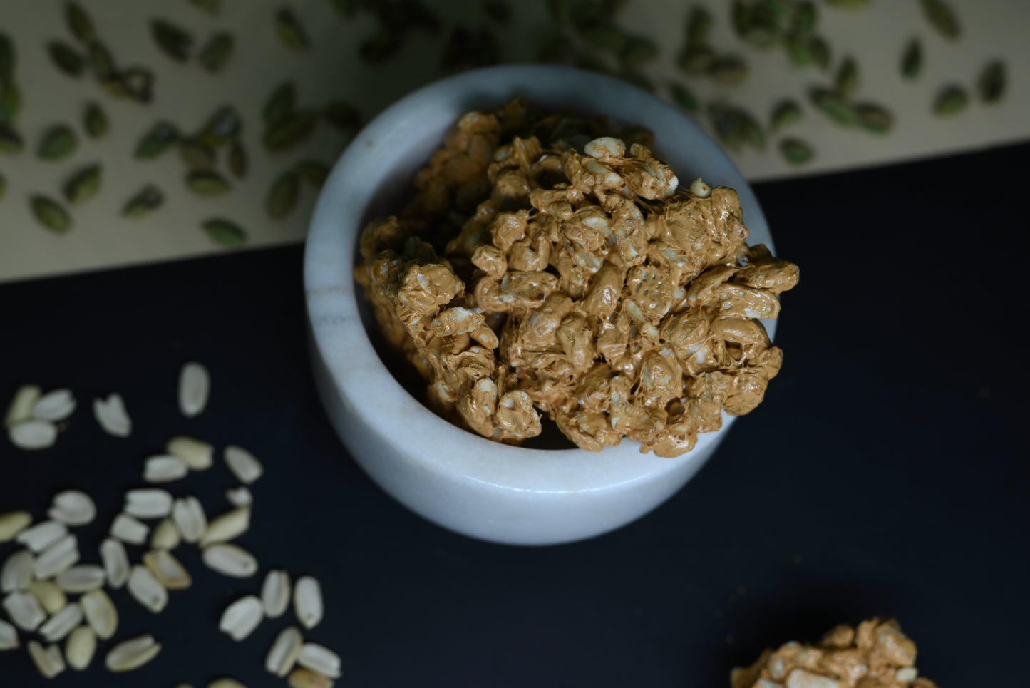 Chocolate peanut chikki 500g box with chikki pieces on wooden table