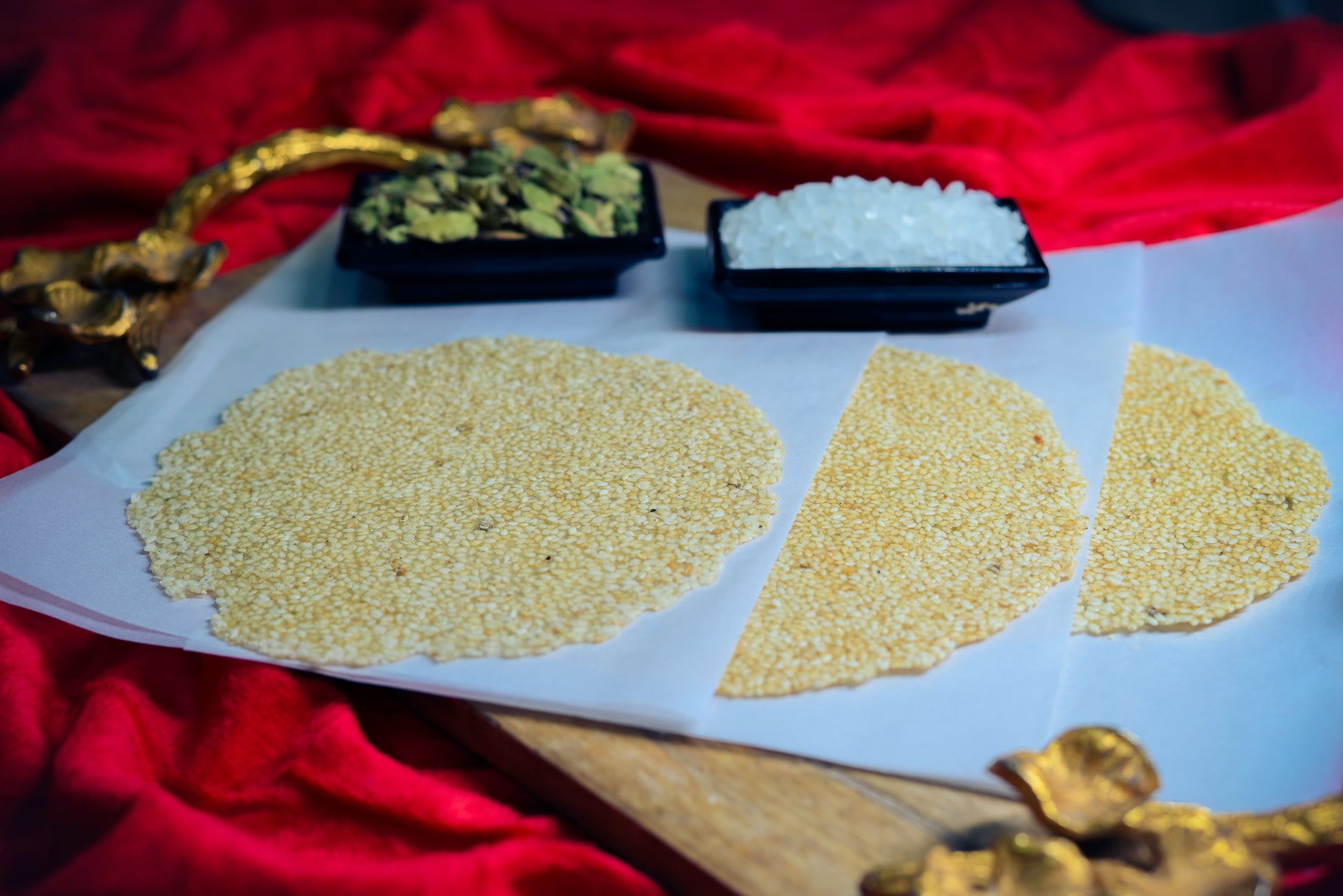 Premium Cardamom Tilpatti sesame sweet pieces on white board