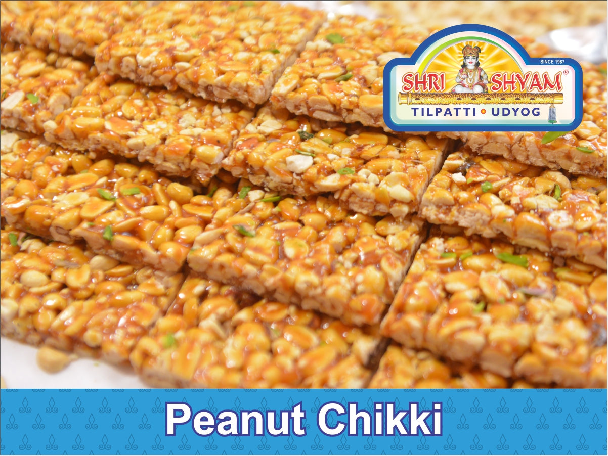 Crispy peanut jaggery chikki stacked on blue cloth
