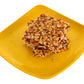 Crispy peanut jaggery chikki stacked on blue cloth
