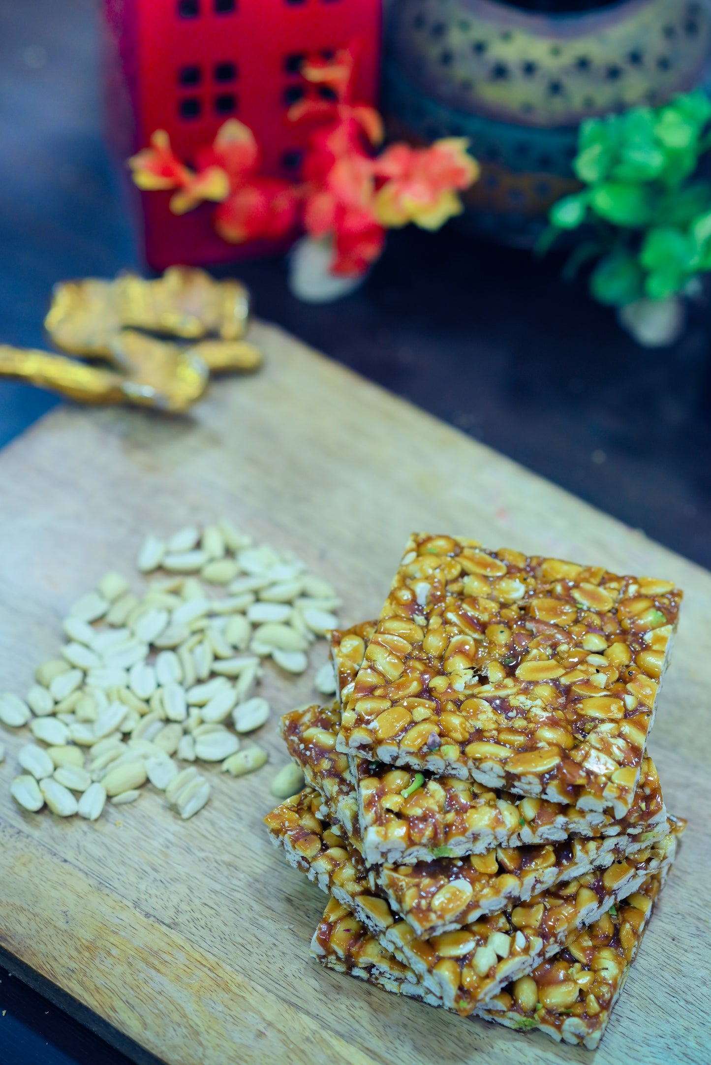 Crispy peanut jaggery chikki stacked on blue cloth