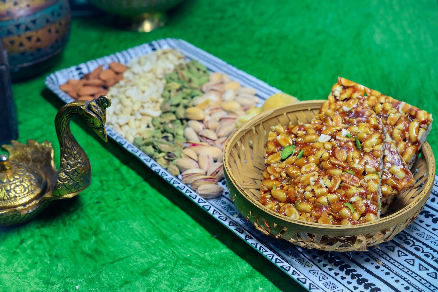 Crispy peanut jaggery chikki stacked on blue cloth