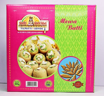 A box of Shree Shyam Mewabati Indian sweet treats with the product visible through a window on the packaging. The background is pink with green patterns, and text indicates the weight of 200 grams.