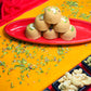 Traditional Mewabati mithai arranged on decorative festive background