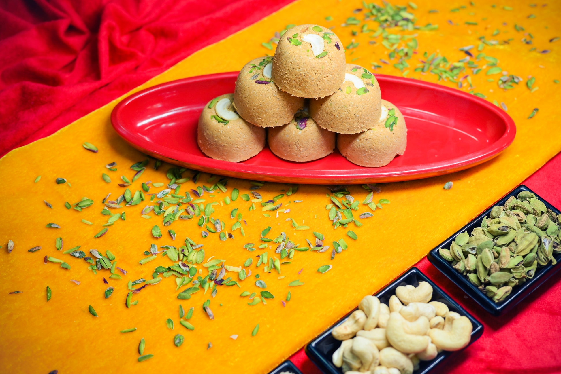 Traditional Mewabati mithai arranged on decorative festive background