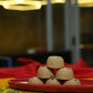 Traditional Mewabati mithai arranged on decorative festive background