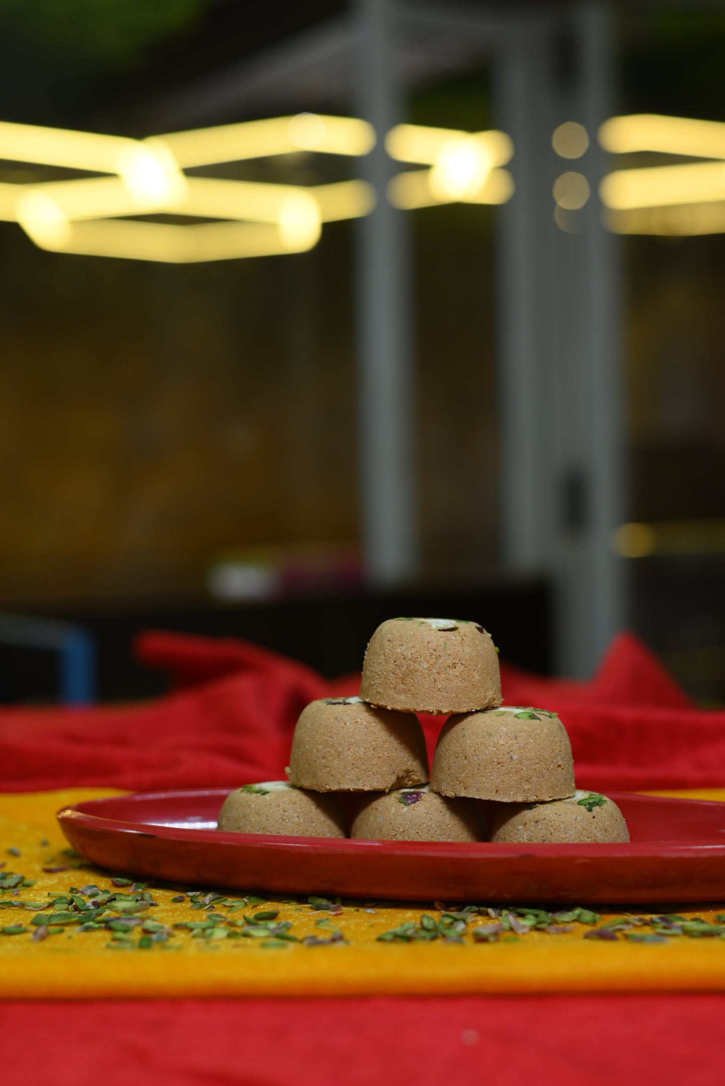 Traditional Mewabati mithai arranged on decorative festive background