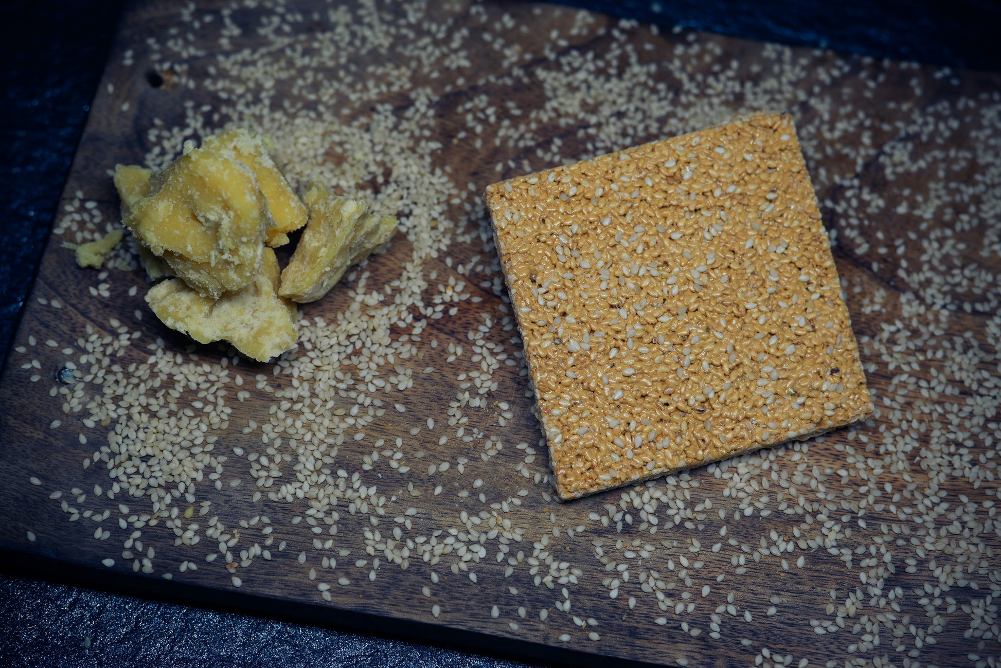 Rajasthani Rewra 500g box with sesame sweet pieces on wooden board