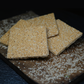 Authentic Rewra sesame jaggery sweet squares on dark background